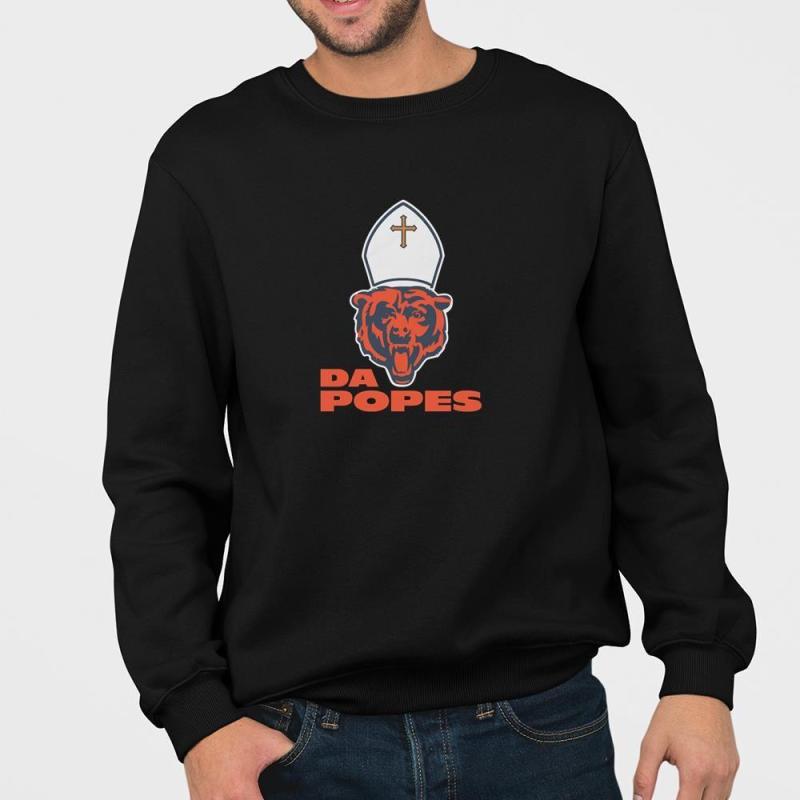 A man wearing a black sweatshirt with a bear wearing a sailor's hat.