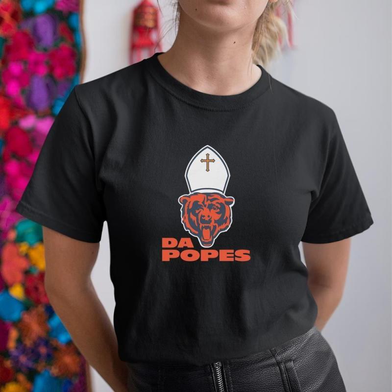 A woman wearing a black shirt with a bear wearing a sailor's hat.