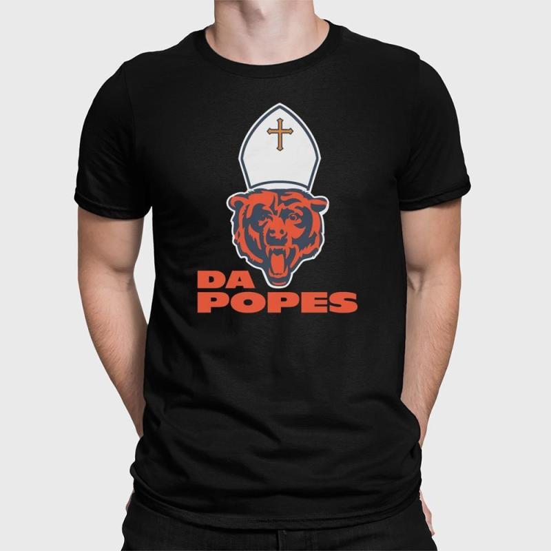 A man wearing a black shirt with a football on it.