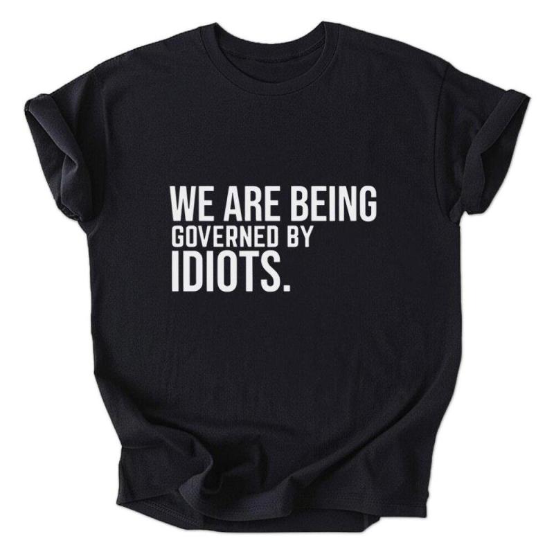 A black shirt that says we are being governed by idiots