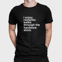 A man wearing a black shirt that says I enjoy romantic walks through the hardware store.