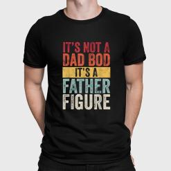A man wearing a black shirt that says it's not a dad bod, it's a father figure.