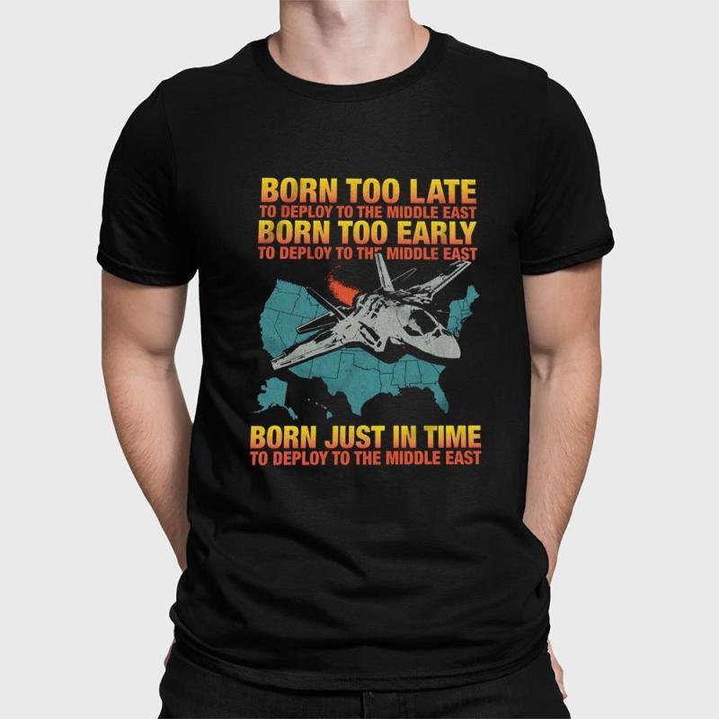 A man wearing a black shirt that says born too late to deploy to the middle east