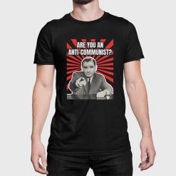 A man wearing a black shirt that says are you an anti-communist?