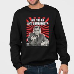 A man wearing a black sweatshirt that says are you an anti communist?