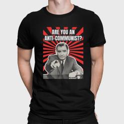 A man wearing a black shirt that says are you an anti-communist?