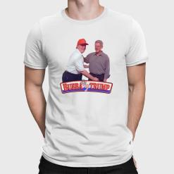A man wearing a white t-shirt with a picture of Trump and Bill Clinton shaking hands.