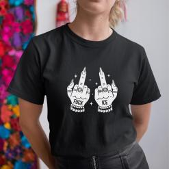 A woman wearing a black shirt that says fuck ice.