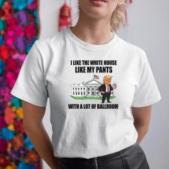 A woman wearing a white shirt that says i like the white house like my pants with a lot of ballroom