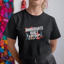 A woman wearing a black shirt that says immigrants built america.