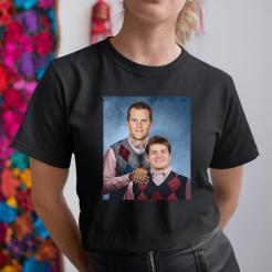 A woman wearing a black shirt with a photo of two men.