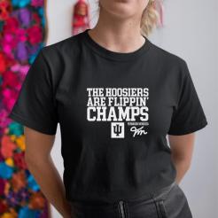 A woman wearing a black shirt that says the hoosiers are flippin' champs.