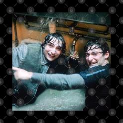 A couple of men standing next to each other in a room.