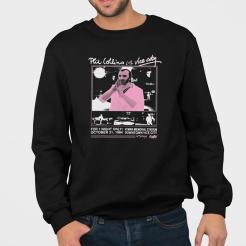 A man wearing a black sweatshirt with a picture of a man on it